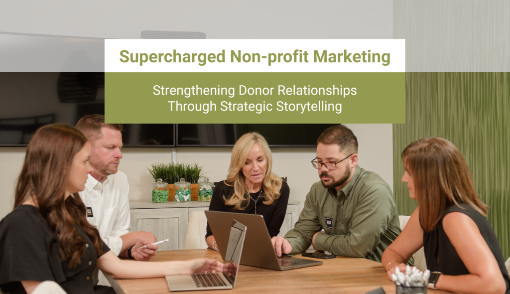 MJ2 Marketing team collaborating around a table with laptops, showcasing nonprofit marketing strategy through storytelling.